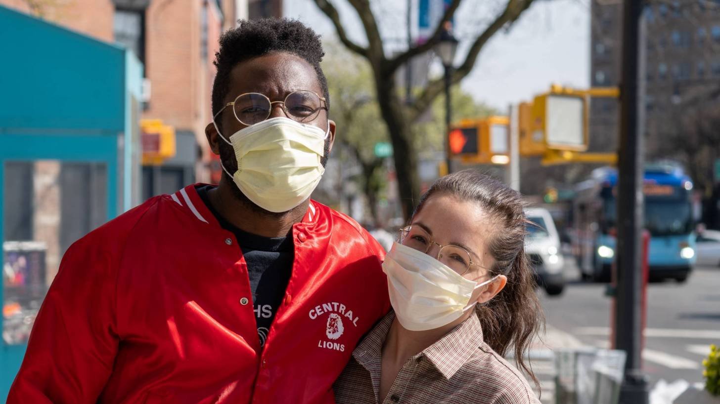 couple outside with masks on in city
